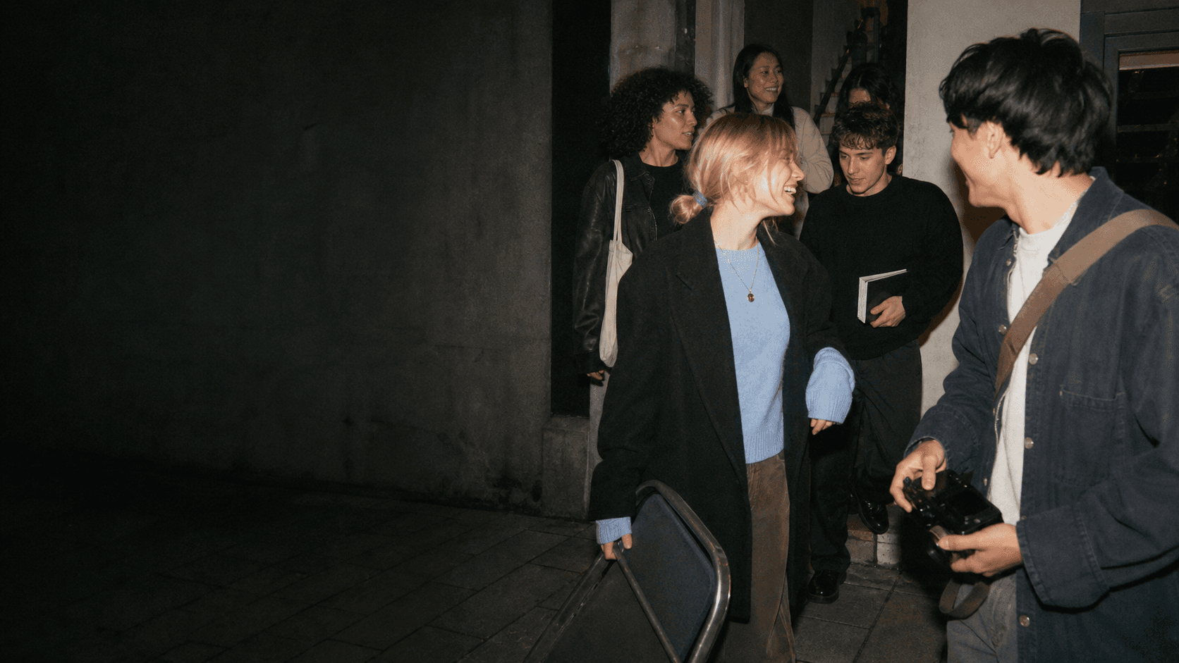 A group of young people leaving an evening gathering